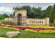 Welcome to Tresana: An inviting community entrance with colorful flowerbeds and beautiful landscaping at 9581 Firenze Way, Highlands Ranch, CO 80126