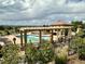 Community pool area with pergola, lounge chairs and mountain views at 9581 Firenze Way, Highlands Ranch, CO 80126