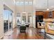 Light filled dining room with large windows and an adjacent kitchen area at 9581 Firenze Way, Highlands Ranch, CO 80126