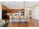 Kitchen island with granite countertops, pendant lighting, and comfortable seating at 9581 Firenze Way, Highlands Ranch, CO 80126