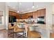 Close up on the kitchen island with granite countertops, pendant lights, and bar seating at 9581 Firenze Way, Highlands Ranch, CO 80126