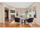 This living room features a fireplace, lots of natural light, and hardwood floors at 9581 Firenze Way, Highlands Ranch, CO 80126