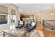 Living room view to kitchen and stairs with hardwood floors at 9581 Firenze Way, Highlands Ranch, CO 80126