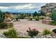 Beautiful outdoor terrace with stone accents, lush landscaping, colorful flowers and mountain views at 9581 Firenze Way, Highlands Ranch, CO 80126