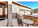 Outdoor patio area with brick paving and a view of the garage at 9581 Firenze Way, Highlands Ranch, CO 80126