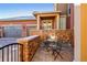 Charming outdoor patio with a decorative stone wall and seating area, perfect for relaxing at 9581 Firenze Way, Highlands Ranch, CO 80126