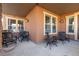 Covered patio provides an inviting outdoor space with comfortable seating and overhead lighting at 9581 Firenze Way, Highlands Ranch, CO 80126