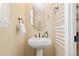 Charming powder room boasts a pedestal sink and stylish fixtures at 9581 Firenze Way, Highlands Ranch, CO 80126