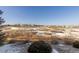 Scenic view of a snow-dusted landscape with scattered homes in the distance at 9581 Firenze Way, Highlands Ranch, CO 80126