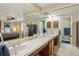 Spacious bathroom featuring double sinks, large mirrors, and access to the bedroom at 4967 E Lake Ave, Centennial, CO 80121