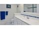 Charming bathroom features wainscotting, blue accents, and tiled floor at 4967 E Lake Ave, Centennial, CO 80121