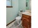 Charming half bathroom features tiled floor, wood vanity and decorative mirror with vintage decor at 4967 E Lake Ave, Centennial, CO 80121