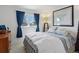 Bedroom with a large window, bright decor, and comfortable bedding at 4967 E Lake Ave, Centennial, CO 80121