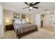 Comfortable bedroom with neutral tones, a king bed, and view of the staircase at 4967 E Lake Ave, Centennial, CO 80121