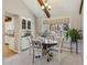 Cozy dining area with a wooden table, comfortable chairs, natural lighting, and built-in display cabinets at 4967 E Lake Ave, Centennial, CO 80121