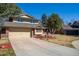 Charming two-story home with a well-maintained lawn, inviting entrance, and a spacious two car garage at 4967 E Lake Ave, Centennial, CO 80121