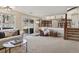 Bright living room with sliding glass doors to the yard and open staircase to the kitchen at 4967 E Lake Ave, Centennial, CO 80121