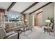 Bright living room featuring large windows, exposed beams, neutral color palette and comfortable seating at 4967 E Lake Ave, Centennial, CO 80121