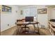 Functional home office with desk, computer, and ample natural light from a large window at 4967 E Lake Ave, Centennial, CO 80121