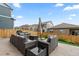 Cozy patio area in yard with comfortable seating, a fire pit, and a fenced perimeter at 14075 Scarlet Sage St, Parker, CO 80134