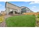 A spacious backyard features a well-manicured lawn, patio seating, and a privacy fence at 14075 Scarlet Sage St, Parker, CO 80134