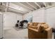 Finished basement with living area, drop ceiling and recessed lights and work space at 14075 Scarlet Sage St, Parker, CO 80134