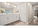 Bright bathroom featuring double sinks with a large framed mirror and tiled floors at 14075 Scarlet Sage St, Parker, CO 80134