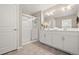 Clean bathroom with double vanity, framed mirror, and a glass-enclosed shower at 14075 Scarlet Sage St, Parker, CO 80134