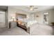 Spacious bedroom with a decorative bed frame, bench, and side tables with lamps at 14075 Scarlet Sage St, Parker, CO 80134