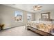 Bright bedroom features neutral walls, plush carpet, and a large window with neighborhood views at 14075 Scarlet Sage St, Parker, CO 80134