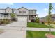 Charming two-story home with a well-manicured lawn, two-car garage, and inviting front porch at 14075 Scarlet Sage St, Parker, CO 80134