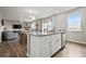 Kitchen island featuring a stainless steel dishwasher, sink, and white cabinets at 14075 Scarlet Sage St, Parker, CO 80134