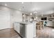 Kitchen island featuring stainless steel dishwasher, sink and seating area at 14075 Scarlet Sage St, Parker, CO 80134