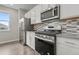 Close-up of the kitchen with stainless steel appliances and a modern backsplash at 14075 Scarlet Sage St, Parker, CO 80134