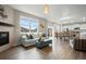 Open concept living room and kitchen with fireplace at 14075 Scarlet Sage St, Parker, CO 80134