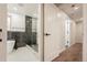 Bathroom featuring a modern soaking tub and a frameless walk-in shower with marble tile at 11383 W 28Th Ave, Lakewood, CO 80215