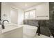 Bright bathroom featuring a soaking tub, and a double vanity at 11383 W 28Th Ave, Lakewood, CO 80215