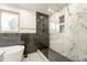 Stylish bathroom featuring a soaking tub, walk-in shower with black and white marble tile at 11383 W 28Th Ave, Lakewood, CO 80215