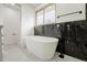 Bright bathroom featuring a soaking tub, and modern fixtures at 11383 W 28Th Ave, Lakewood, CO 80215
