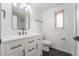 Modern bathroom features a white vanity, black fixtures, and dark tile flooring at 11383 W 28Th Ave, Lakewood, CO 80215
