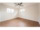 This spacious bedroom has two windows with wood floors and a ceiling fan at 11383 W 28Th Ave, Lakewood, CO 80215