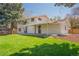 Charming two-story home with a well-maintained lawn and covered patio at 11383 W 28Th Ave, Lakewood, CO 80215