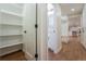 Hallway with an open pantry, hardwood floors, and white trim throughout the home at 11383 W 28Th Ave, Lakewood, CO 80215