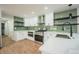 Bright kitchen showcasing stainless steel appliances, white countertops, and stylish black shelving at 11383 W 28Th Ave, Lakewood, CO 80215