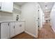 Well-lit laundry room with modern fixtures, countertop space, and ample cabinet storage at 11383 W 28Th Ave, Lakewood, CO 80215