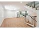 Open-concept space showcasing a staircase with black railings and a modern kitchen area at 11383 W 28Th Ave, Lakewood, CO 80215