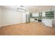 Spacious living room with an open floor plan leading into a well-lit kitchen at 11383 W 28Th Ave, Lakewood, CO 80215