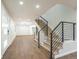Bright entryway featuring a modern staircase with black railings and wood steps at 11383 W 28Th Ave, Lakewood, CO 80215
