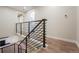 Modern staircase featuring metal railing and hardwood floors with updated lighting at 11383 W 28Th Ave, Lakewood, CO 80215