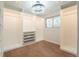 Spacious walk-in closet with custom shelving, drawers, and a stylish chandelier at 11383 W 28Th Ave, Lakewood, CO 80215